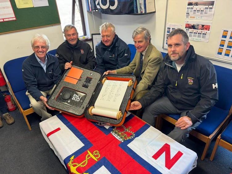 Teignmouth RNLI volunteers Brian Harnett, Alan Harwood, Adrian Knowles, Lord Clifford and Matt Slader sign 200th Anniversary Scroll. Photo: RNLI