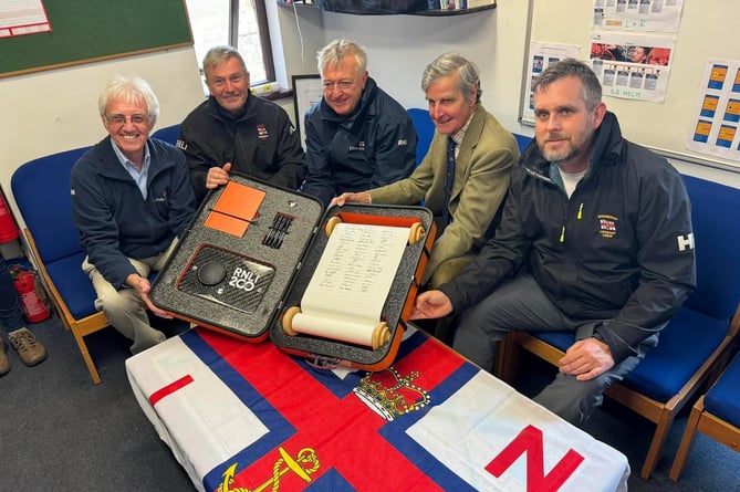 Teignmouth RNLI volunteers Brian Harnett, Alan Harwood, Adrian Knowles, Lord Clifford and Matt Slader sign 200th Anniversary Scroll. Photo: RNLI