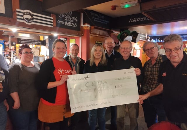 Quiz team from the Marine Tavern in Dawlish receive their prize from the Rotary Quiz