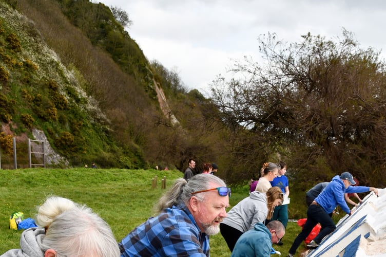Volunteers hard at work with their paintbrushes at the Teignmouth Letters