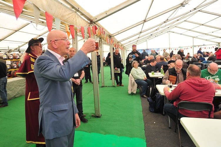 Newton Abbot mayor Cllr David Corney-Walker raises a glass to officially open Maltingsfest 2024