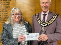 Seventh stint as mayor for councillor as cheque handed to charity 