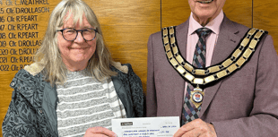 Seventh stint as mayor for councillor as cheque handed to charity 