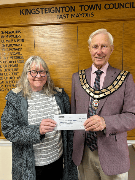 KingsCare's Maggie Bonnell receiving a cheque worth more than £100 from Kingsteignton mayor, Cllr Ron Peart.