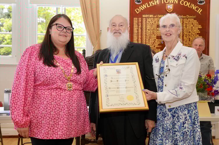 Dawlish's first Honorary Freeman Steve Cunliffe, with wife Caroline, presented with his certificate by outgoing Mayor Rosie Dawson 
