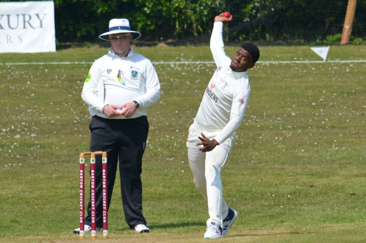 Ipplepen's Bajun signing Nathan Forde bowling down the hill at Barton