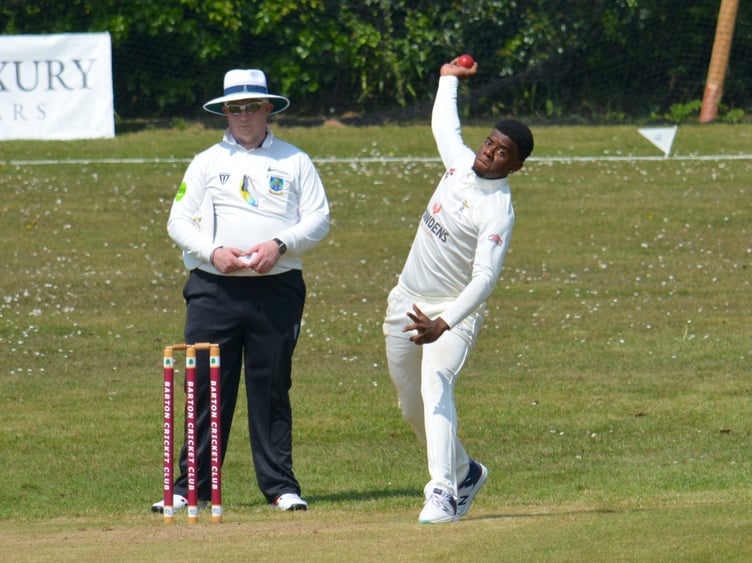 Ipplepen's Bajun signing Nathan Forde bowling down the hill at Barton