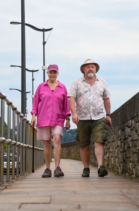 Teignmouth Town Councillor Steve Walsh strolls along Teignmouth seafront with wife Avenda Burnell Walsh.