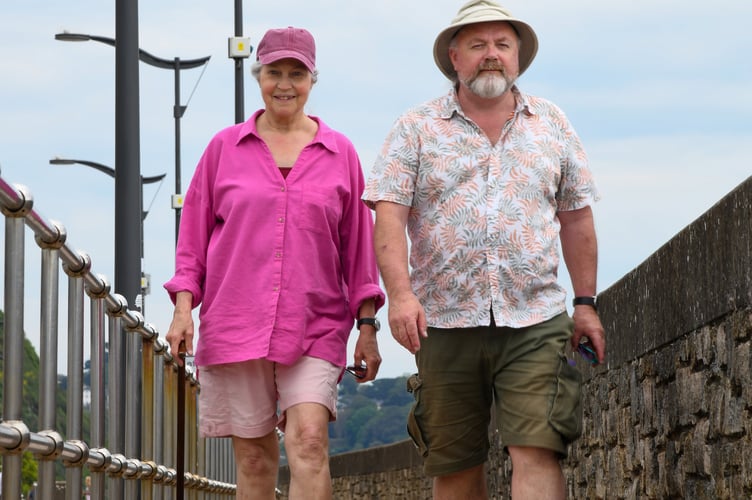 Teignmouth Town Councillor is joined by his wife Avenda Burnell Walsh on a stroll along the seafront.