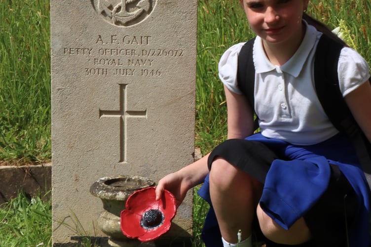 Jasmine Packwood pays tribute to great grandfather Albert Fred Gait at Teignmouth cemetery 