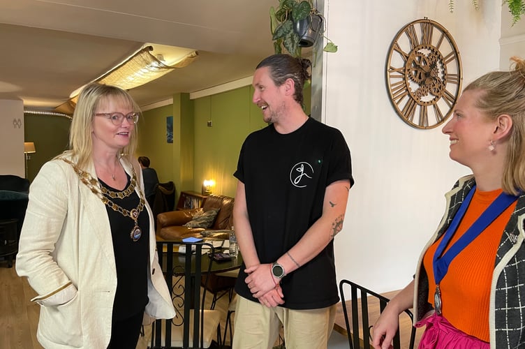Teignmouth Mayor Cate Williams and deputy mayor Chloe Myers chat to the owner of Joanna's Cafe