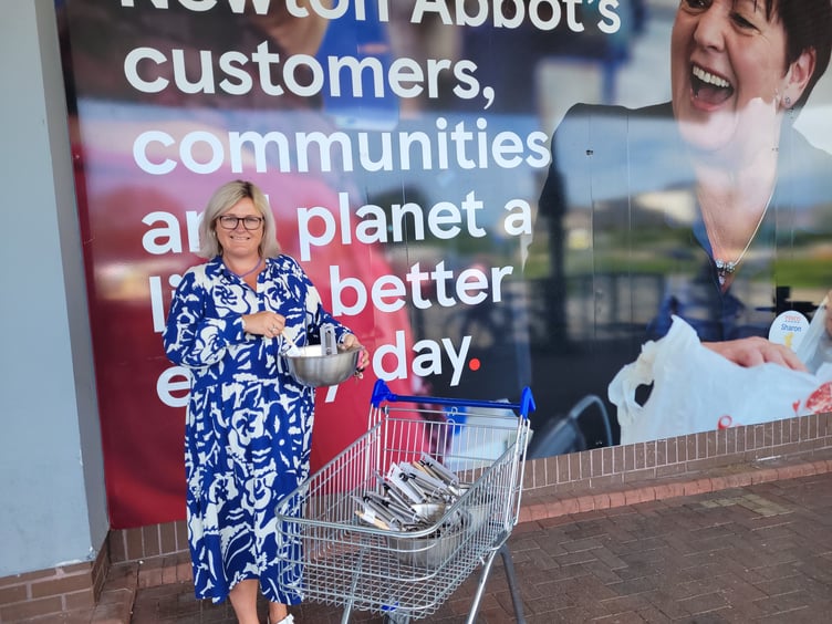 Highweek School administrator Tracy Lowe picks up supplies thanks to Tesco