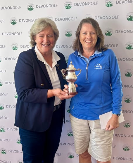 Honiton Golf Club's Lady Captain Catherine Pawley presenting the Women's Senior Champion Trophy to Dainton's Jo Fisher