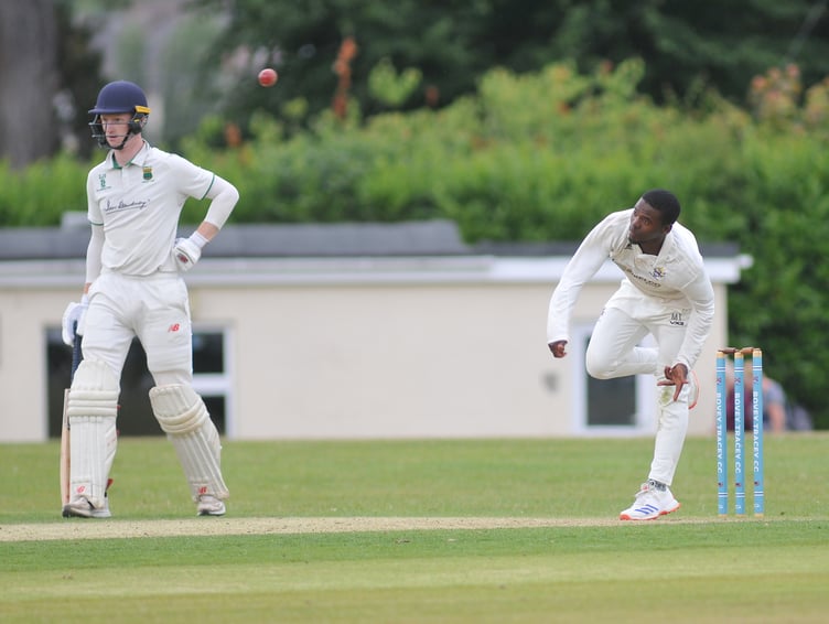 Devon Cricket League Premier  Division West. Bovey Tracey versus Cornwood.  Bovey's Musa Twala lets fly while Cornwood's Elliott Staddon watches and waits