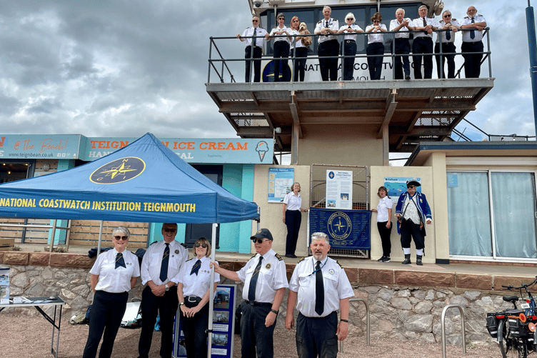 Teignmouth NCI volunteers with 30th anniversary flag