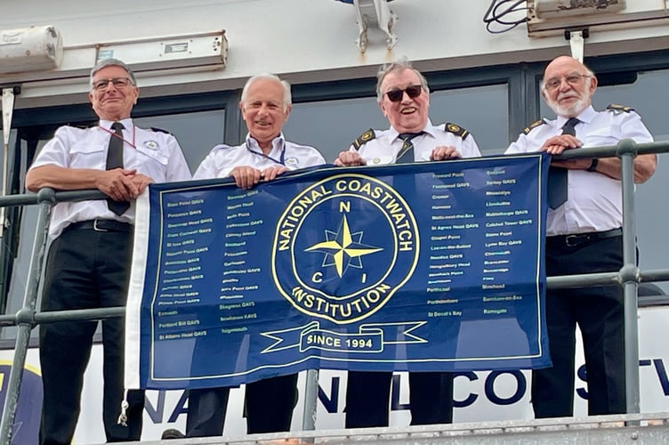 Teignmouth NCI receive the flag as part of the charity's 30th anniversary relay