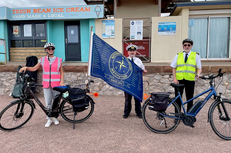 Volunteers prepare to cycle the NCI 30th anniversary flag to Starcross