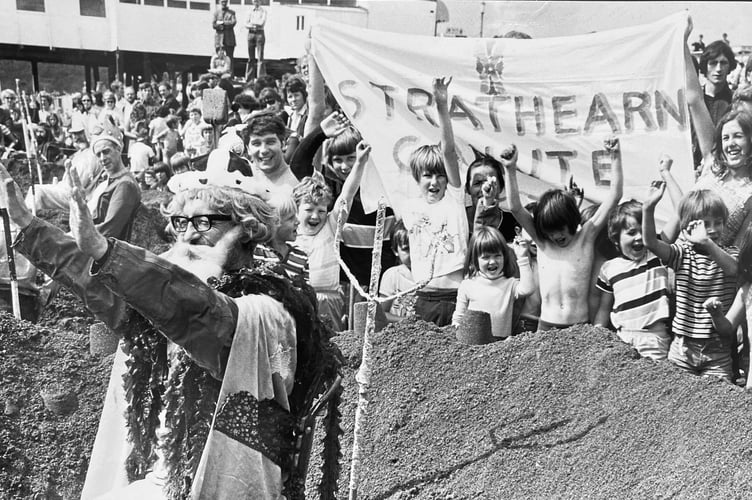 Turning the tide - King Canute from the Strathearn Hotel in Teignmouth attempts to stop the encroaching waves at Teignmouth Regatta in August 1973