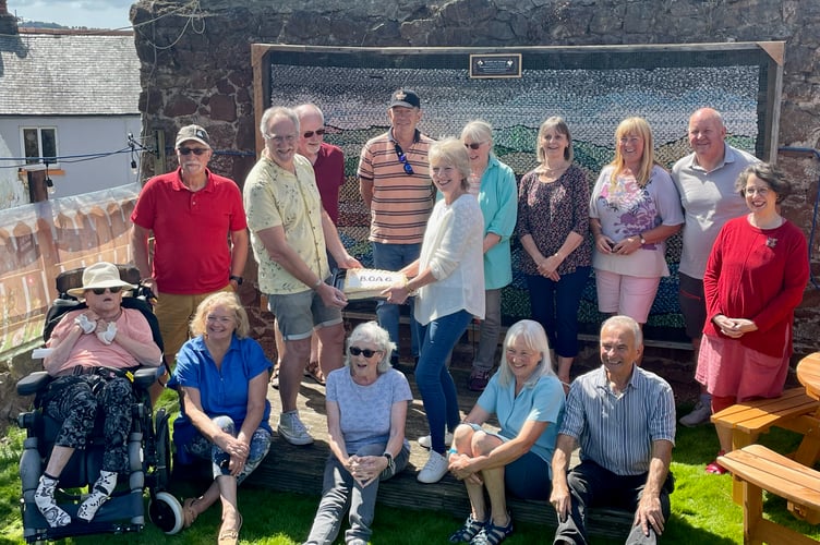 Bishopsteignton Outdoor Art Group celebrate the unveiling of their recycled artwork at the Old Commercial Inn