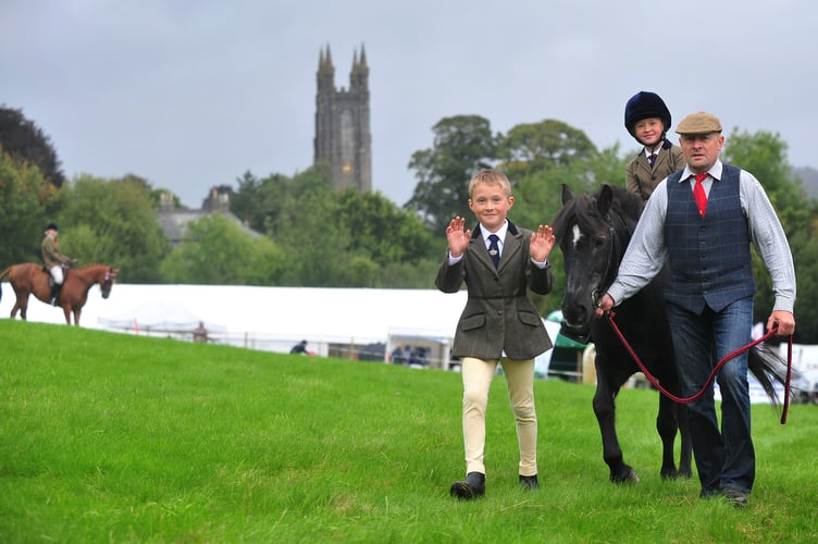 Widecombe Fair. James Guest,  Maddison Guest on Freddie and Tom Guest in the main show ring