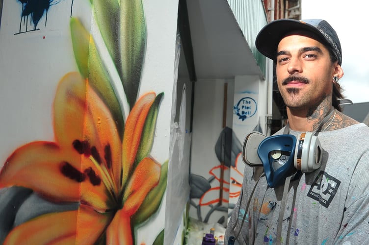 International muralist Sebastian Oyarbide (aka Sebacener) at work in Newton Abbot.