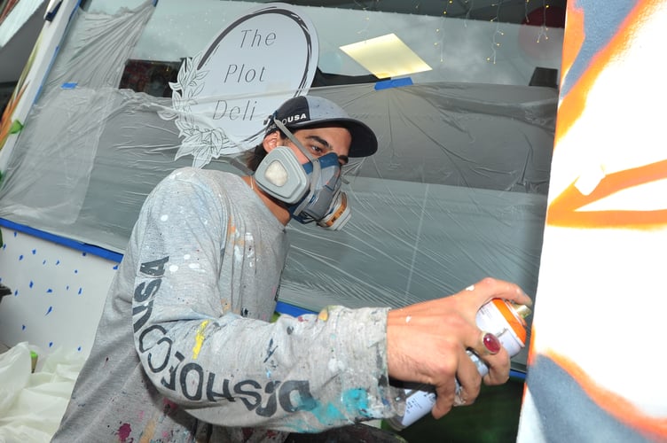 International muralist Sebastian Oyarbide (aka Sebacener) at work in Newton Abbot.