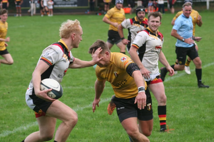 NARFC fullback Josh Southworth delivers a handoff to a Cully defender
