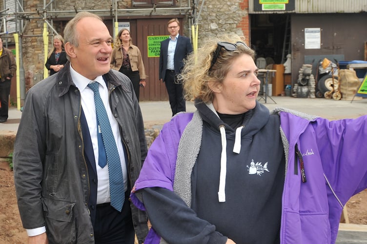Lib Dem leader Ed Davey with Teignmouth Mermaid Peta Howell discussing water quality