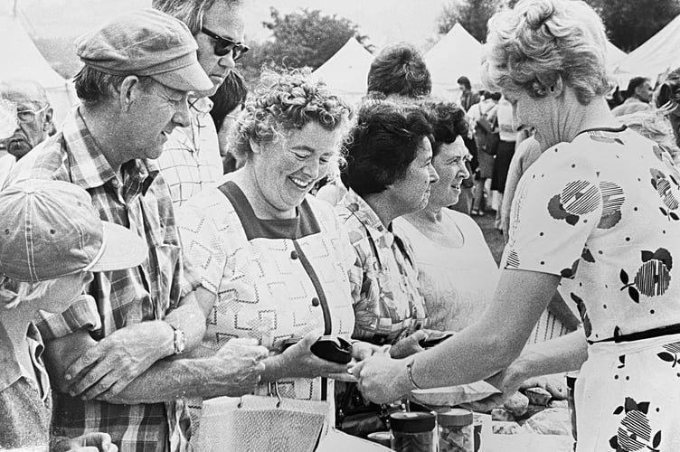Selling like hot cakes. Visitors pack out the home-made cake stall at Manaton Show in August 1977