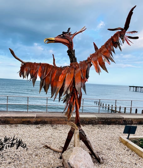 A Phoenix Rising from Climate Change by Amanda Lyon-Smith and Bryan Taylor in the 2024 Teignmouth Recycled Art in the Landscape exhibition.