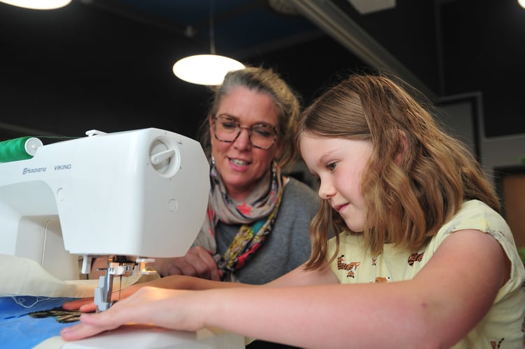Community Tree event at  Newton Abbot Museum. Sofia Nosowska (8) gets a helping hand from mum Katy