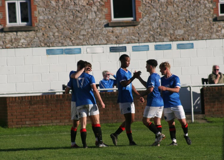 Tate Breslan-Aggrey celebrates his first of the afternoon against Millbrook with teammates