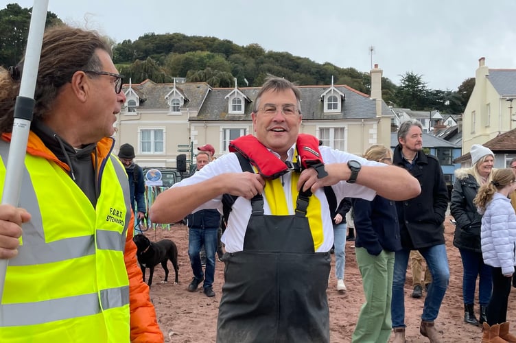 Martin Wrigley MP dons his waders to take a sample from the river for water quality testing