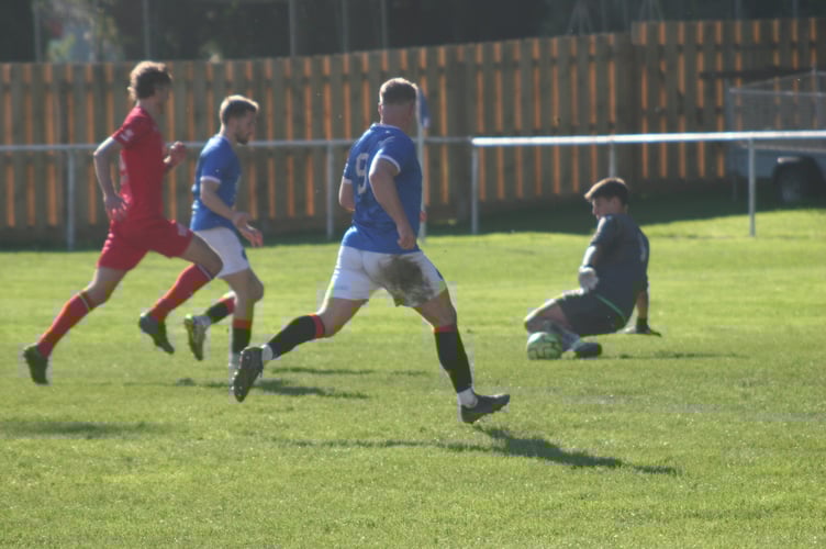 Millbrook's goalkeeper denies Callum Noyce with his legs