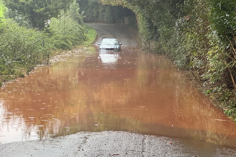 The car stuck in floodwater between Crediton and Sandford.  AQ 5427