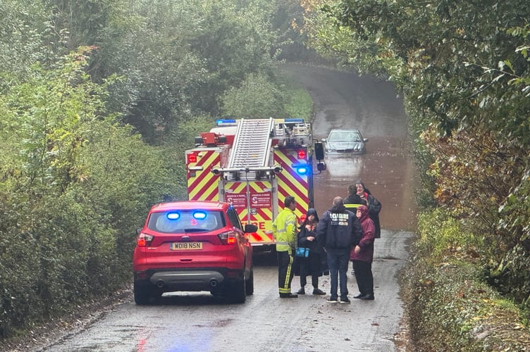 The rescued family talking to firefighters at the scene.  AQ 5416