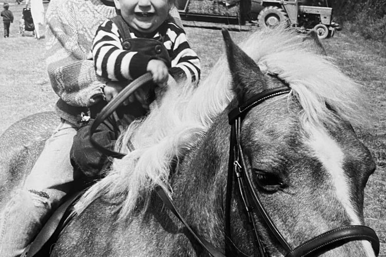 June 1986.  Broadhempston Fete. Clare (7) and Tom Harvey (1) on Tigger