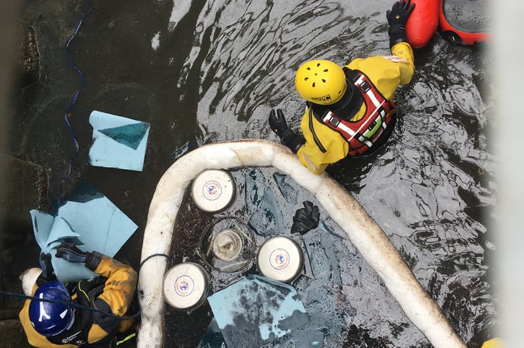 The Environment Agency and fire service removing diesel from the Coney Gut diversion channel at its confluence with the River Taw.

