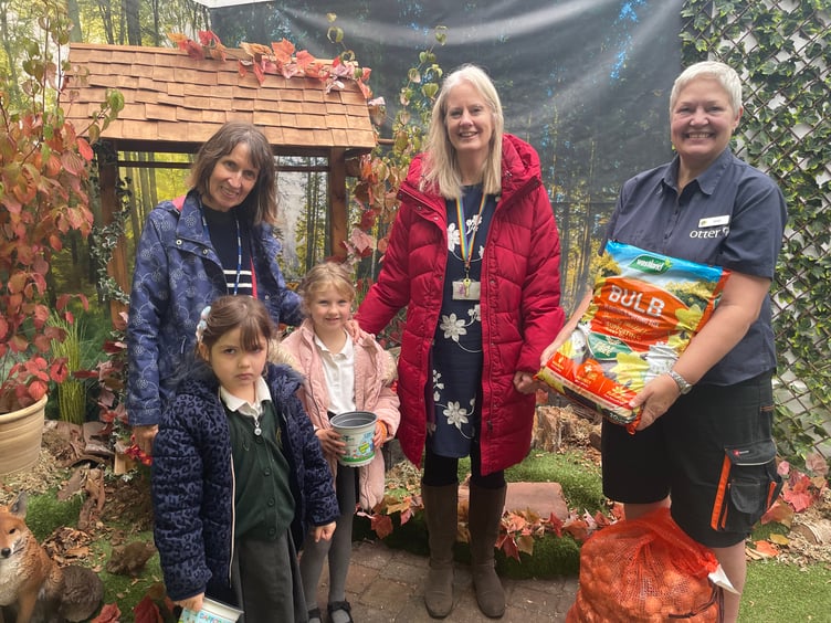 OLSP pupils Scarlett and Isla Rose and staff Trina Evans and Cathy Blatchford collect the donation of daffodil bulbs, compost and pots from Jack's Patch garden centre in Bishopsteignton