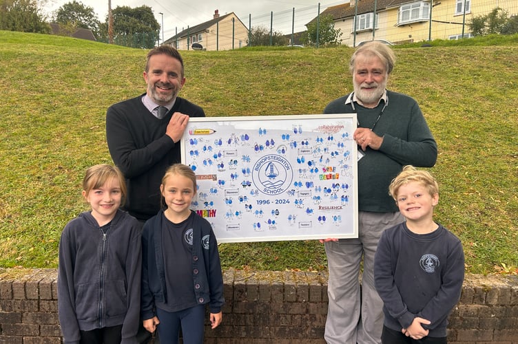 Bishopsteignton Primary School pupils and headteacher Dave Killoran present longstanding governor David Lamboll with artwork to thank him for his 28 years of service
