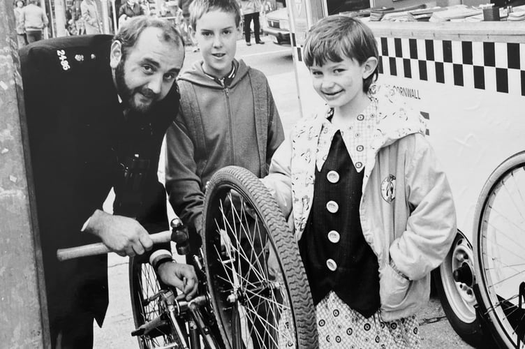 Crime prevention day in Teignmouth's Wellington Street on December 3, 1988. Here PC Lobb is busy marking the bikes of Ben Wells and Elizabeth Marson