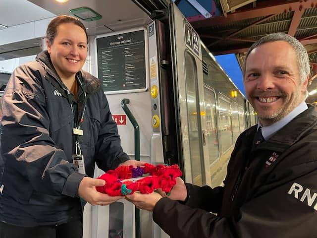 Teignmouth RNLI hand over the specially made wreath to GWR on the Poppy Train. Photo Teignmouth RNLI