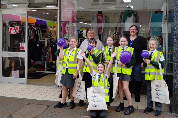 Children from Our Lady & St Patrick RC Primary School outside Age UK on Bank Street in Teignmouth