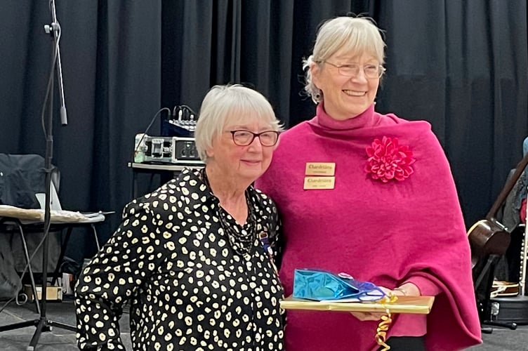Chordettes chair Sue Spear presents founding member Lee Westlake with a token of appreciation at the barbershop singers group golden anniversary celebration November 2024