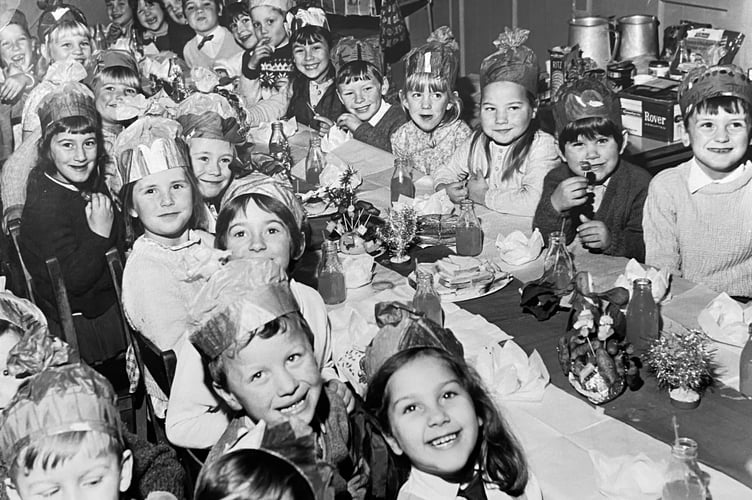 Pupils at Ashburton Primary Shool get ready to tuck-in to a festive spread in December 1970