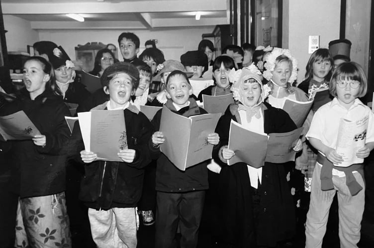 Carol singing youngsters from Ashburton Primary School entertain the crowds at the town's late night Christmas shopping event from December 1997