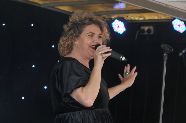 Teignmouth town centre welcomes the start of the Christmas season. Festive songs for the crowds from singer Peta