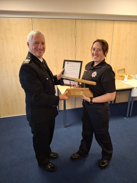 Devon and Somerset Fire and Rescue area manager Wayne Rawlins presents Newton Abbot new recruit Charlie Plyer with the silver axe award
