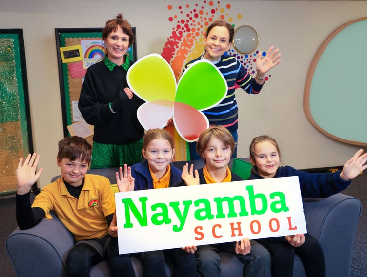 Exminster Primary School children with head Mrs Whalley and Nayamba Trust trustee Rev Vanessa Pestridge after raising money for Nayamba School dinners
