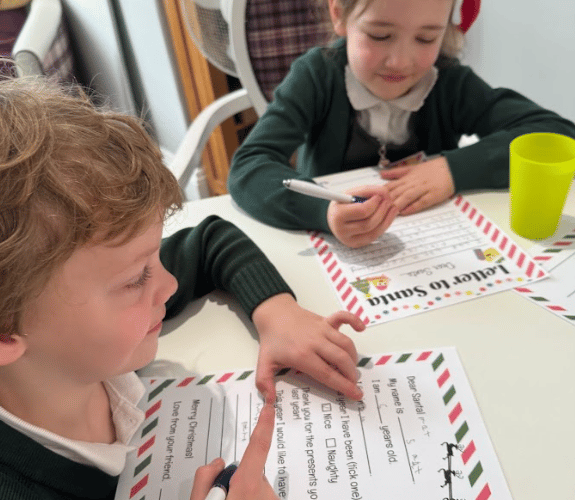 Children from Our Lady and St Patrick Primary School and residents from The White House checking their lists, and checking them twice.